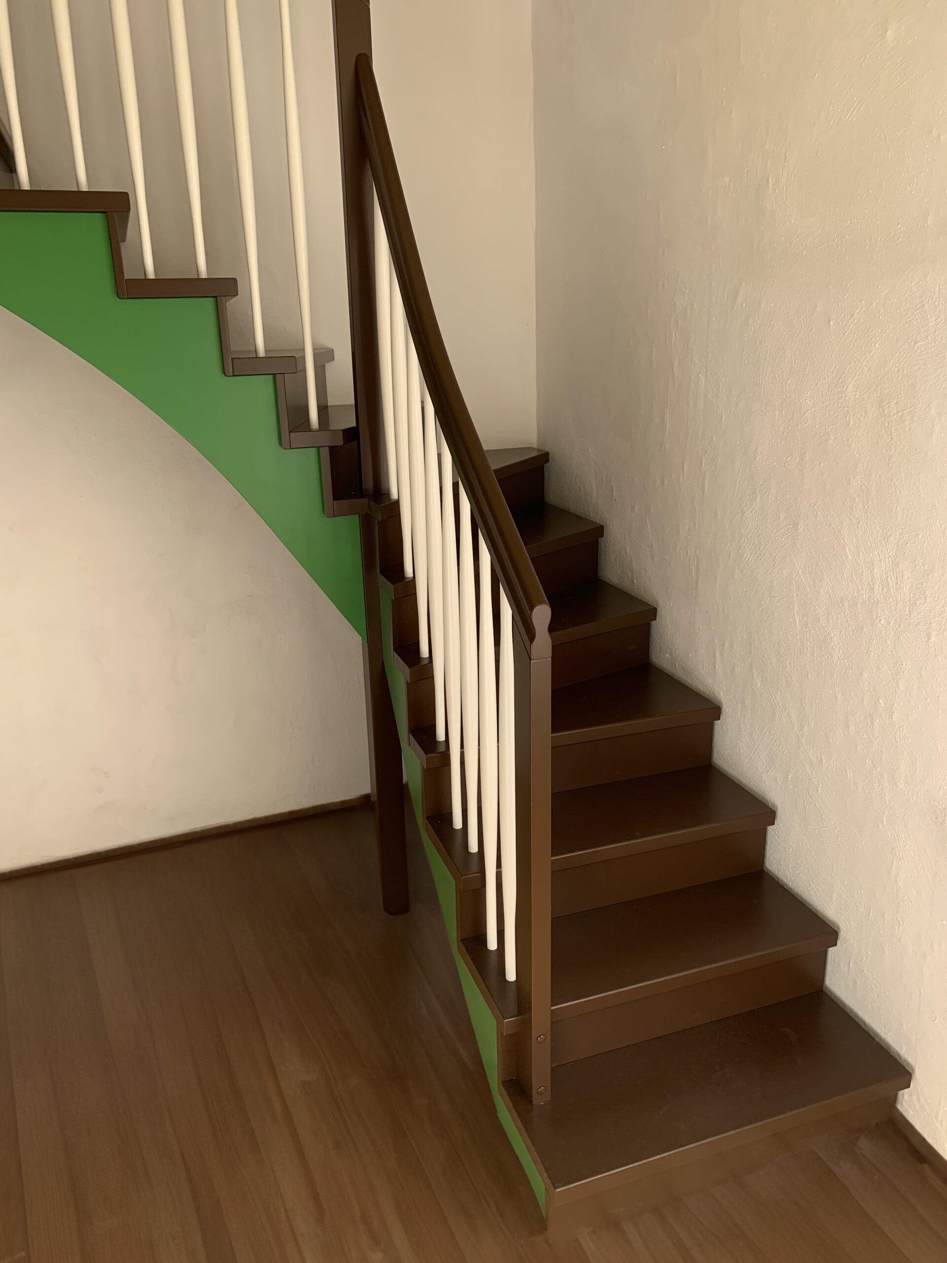 L-shaped staircase with green stringer and beech steps.   