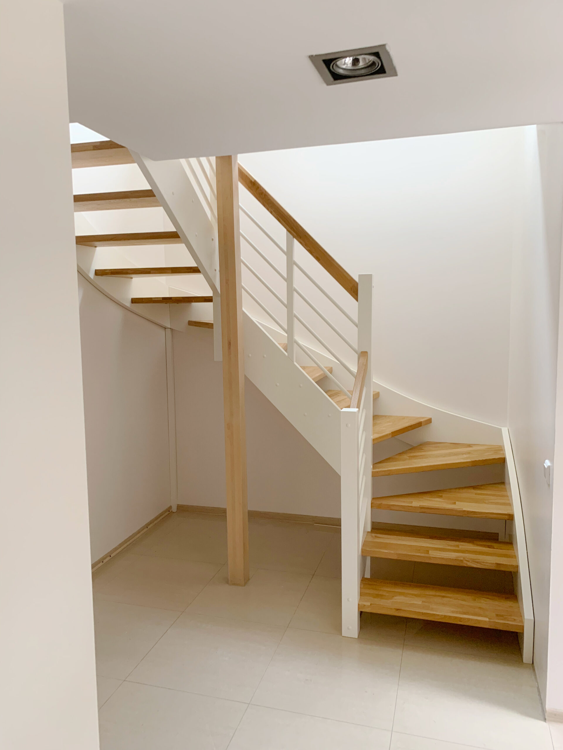 U-shaped staircase with oak steps. Light finish.