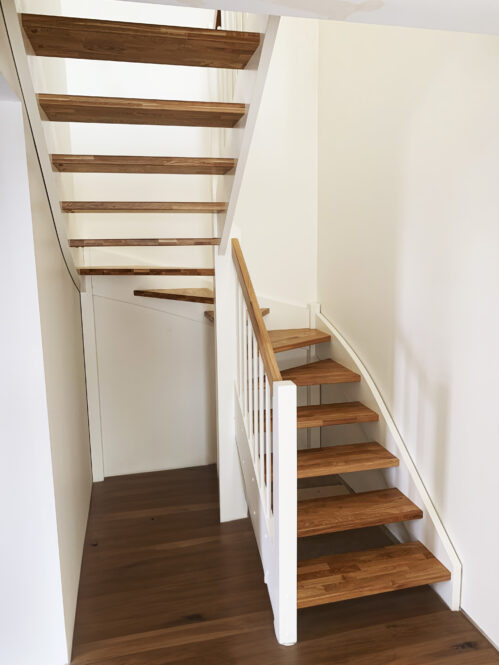 U-shaped staircase with light finish. Oak steps.