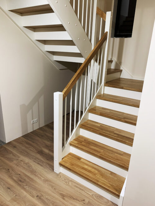 U-shaped staircase with classic stringer and light finish.