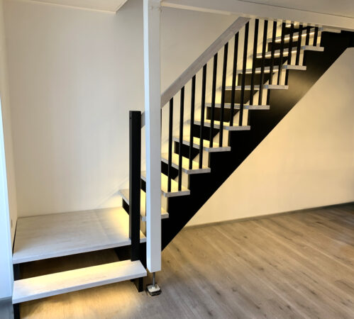 Light-dark combination on an L-shaped staircase. LED lighting.