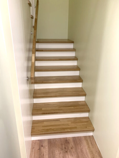 A light finish staircase with oak steps.