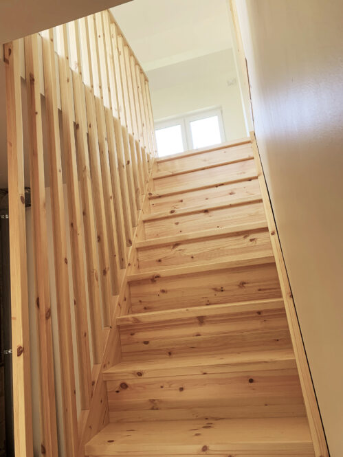 A straight I-shaped staircase with practical railing slats.