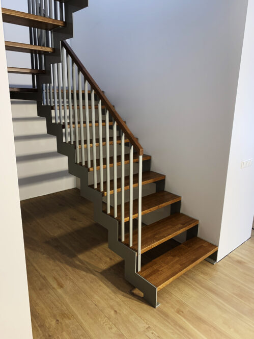 U-shaped staircase with metal baluster. Oak steps.