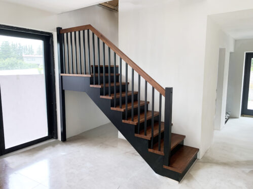 L-shaped staircase with a dark finish. Oak steps.