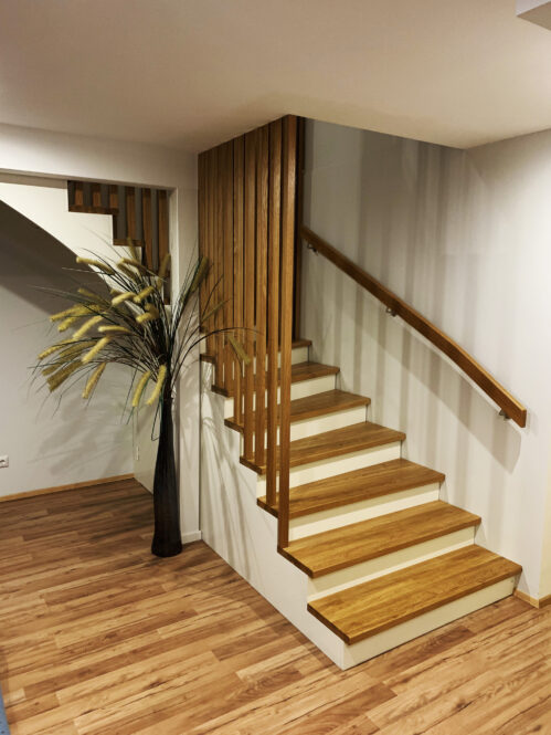 L-shaped staircase with modern stringer and oak steps.