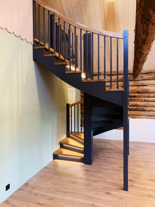 Dark finish spiral staircase with oak steps.