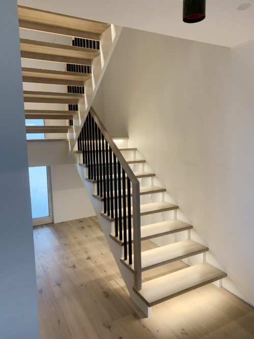 U-shaped staircase with LED lighting and modern stringer.