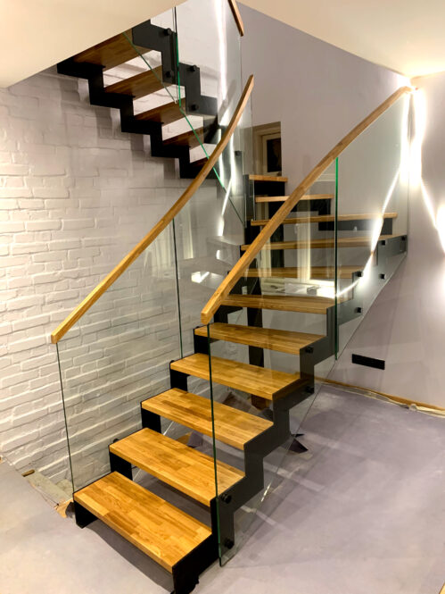 U-shaped staircase. The materials are wood-glass-metal.