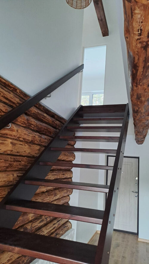 L-shaped staircase with dark-finished pine steps.