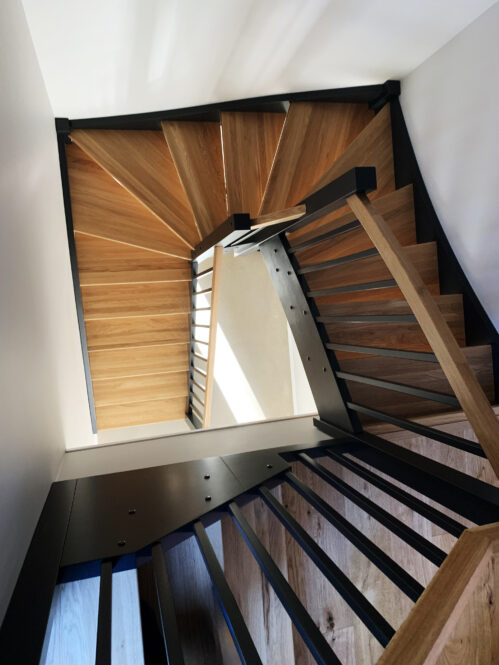 U-shaped staircase with brushed oak steps.