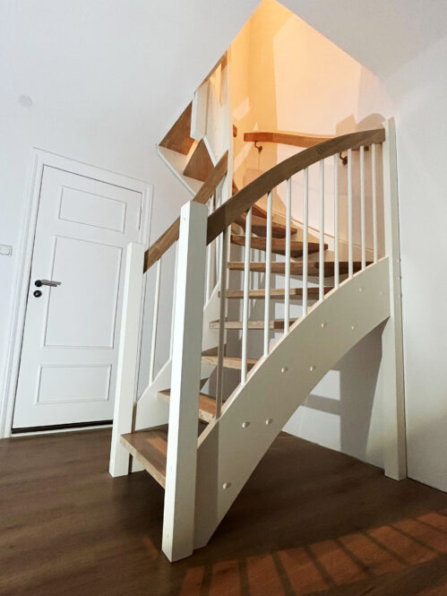 U-shaped staircase with Classic stringers and oak steps.