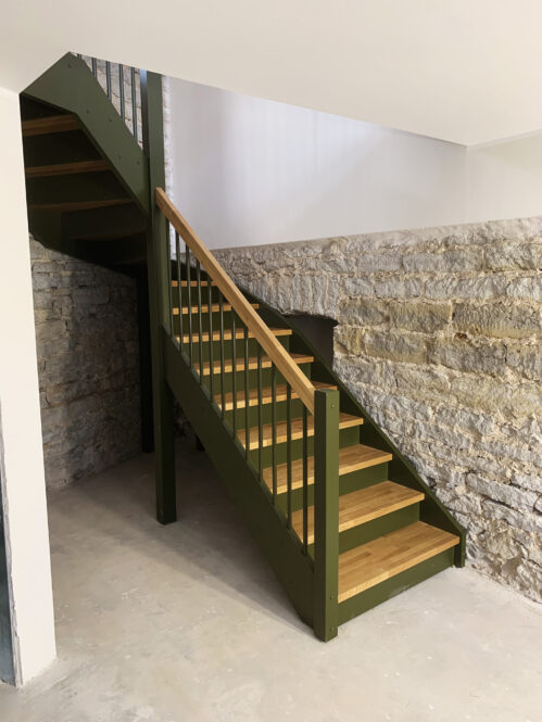 L-shaped staircase with oak steps.