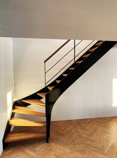 Modern stringer design staircase with oak steps.