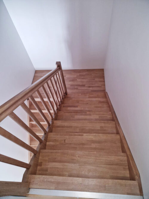 U-shaped staircase with Classic stringers and oak steps.