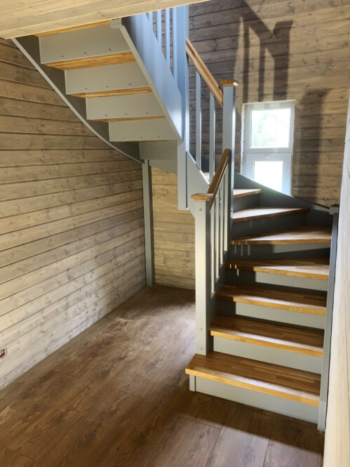 U-shaped staircase with oak steps.