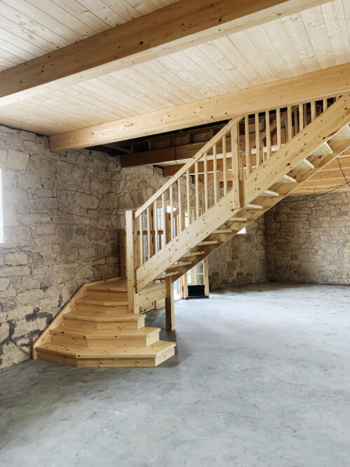 Designer L-shaped staircase with steps made of pine.