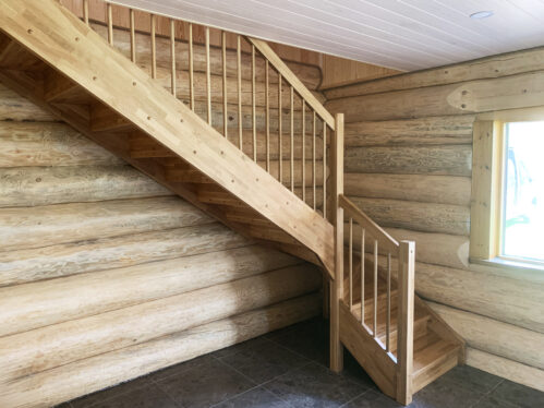 L-shaped staircase with oak steps and light finish.