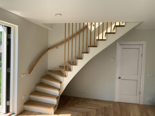 L-shaped staircase with oak steps and LED lighting.