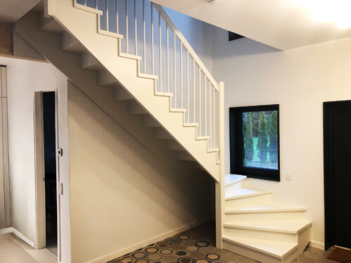 U-shaped staircase with modern stringers and pine steps.