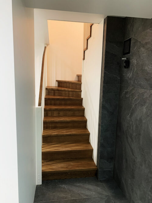 U-shaped staircase with oak steps.